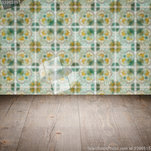 Image of Wood table top and blur vintage ceramic tile pattern wall