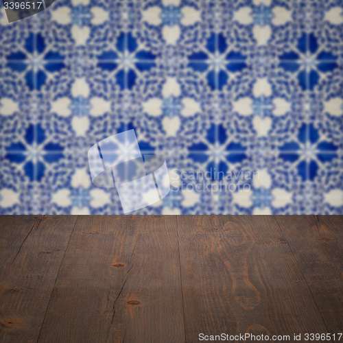 Image of Wood table top and blur vintage ceramic tile pattern wall