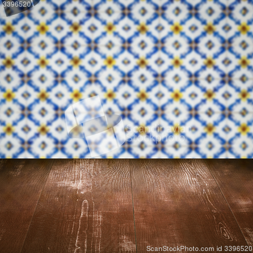 Image of Wood table top and blur vintage ceramic tile pattern wall