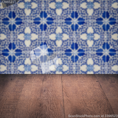 Image of Wood table top and blur vintage ceramic tile pattern wall
