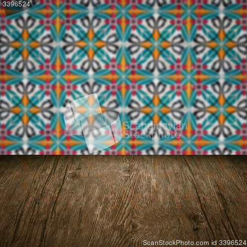 Image of Wood table top and blur vintage ceramic tile pattern wall