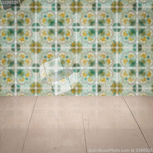 Image of Wood table top and blur vintage ceramic tile pattern wall