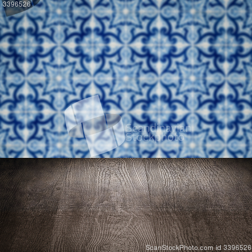 Image of Wood table top and blur vintage ceramic tile pattern wall