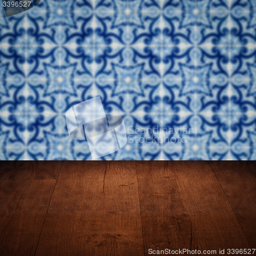 Image of Wood table top and blur vintage ceramic tile pattern wall