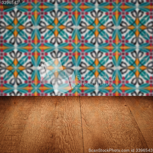 Image of Wood table top and blur vintage ceramic tile pattern wall