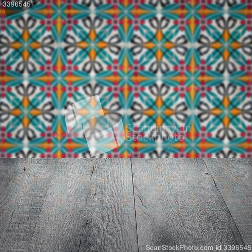 Image of Wood table top and blur vintage ceramic tile pattern wall