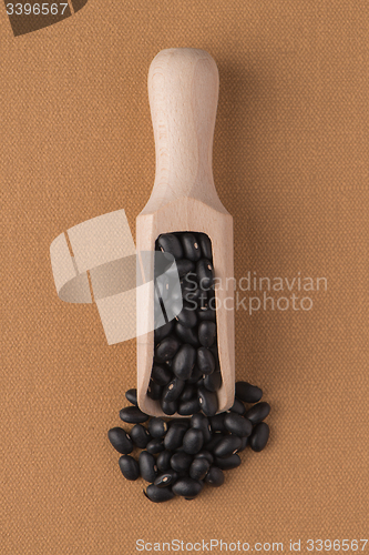 Image of Wooden scoop with black beans