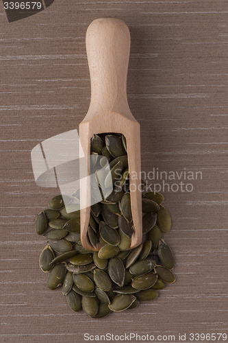 Image of Wooden scoop with pumpkin seeds