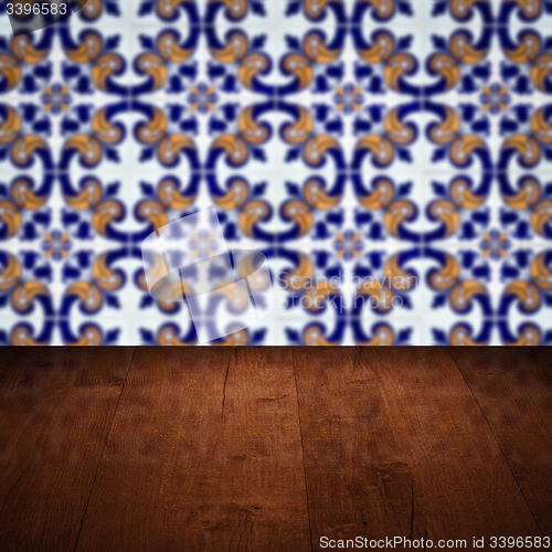 Image of Wood table top and blur vintage ceramic tile pattern wall