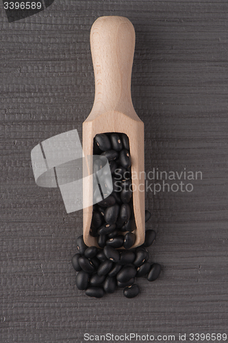 Image of Wooden scoop with black beans