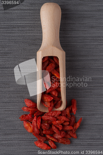 Image of Wooden scoop with dry red goji berries