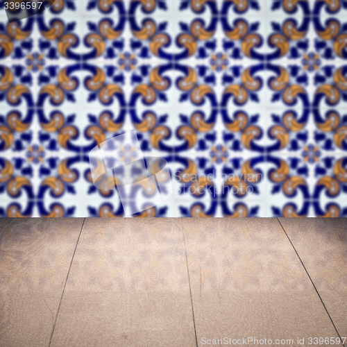 Image of Wood table top and blur vintage ceramic tile pattern wall