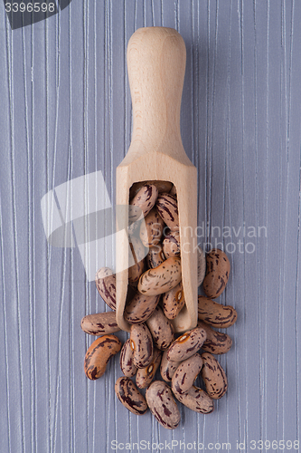 Image of Wooden scoop with pinto beans