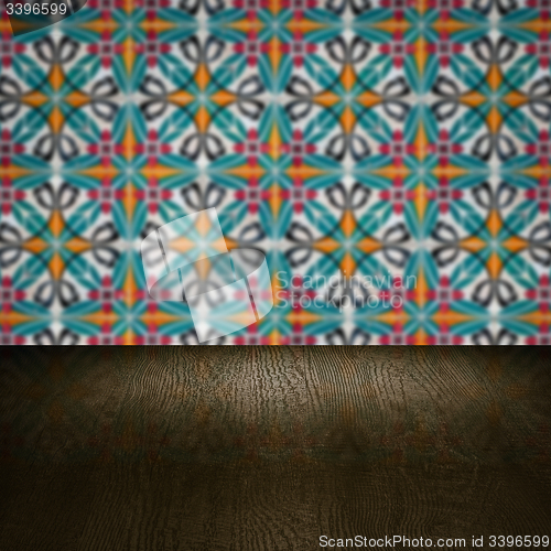 Image of Wood table top and blur vintage ceramic tile pattern wall