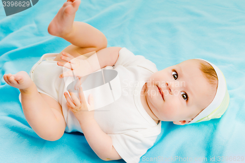 Image of baby lying on a blue plaid