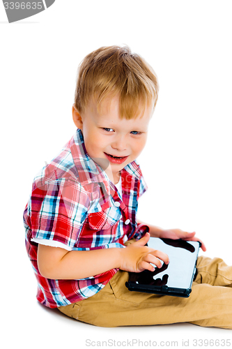 Image of boy with a Tablet PC sitting on the floor