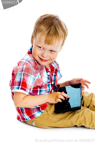 Image of boy with a Tablet PC sitting on the floor