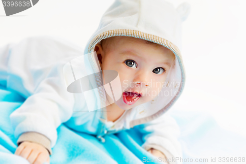 Image of beautiful baby lying on a blue plaid