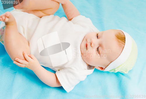 Image of baby lying on a blue plaid