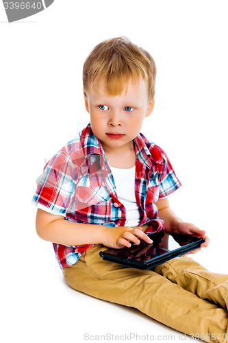 Image of boy with a Tablet PC sitting on the floor