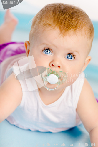 Image of Beautiful baby with a pacifier. Close-up. Studio photo