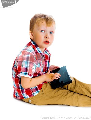 Image of boy with a Tablet PC sitting on the floor