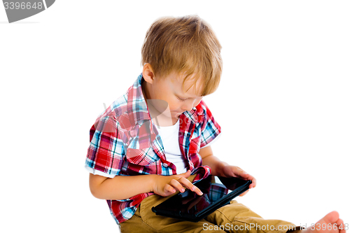 Image of boy with a Tablet PC sitting on the floor