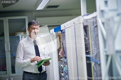 Image of network engineer working in  server room