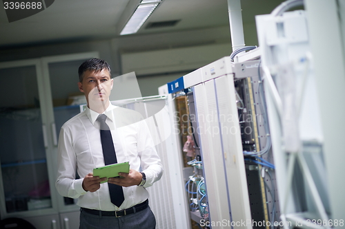 Image of network engineer working in  server room