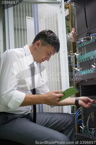 Image of network engineer working in  server room