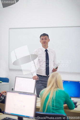 Image of students with teacher  in computer lab classrom