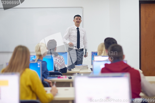 Image of students with teacher  in computer lab classrom