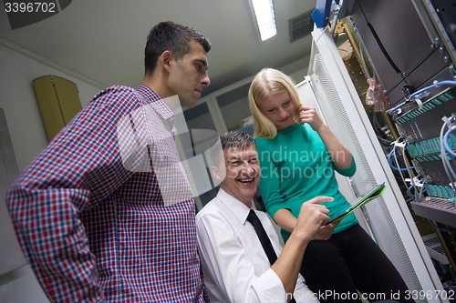 Image of network engeneers working in network server room