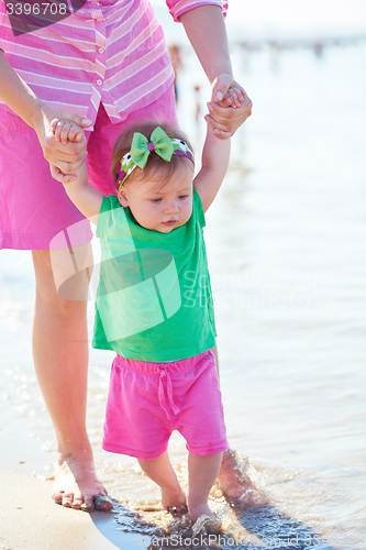 Image of mom and baby on beach  have fun