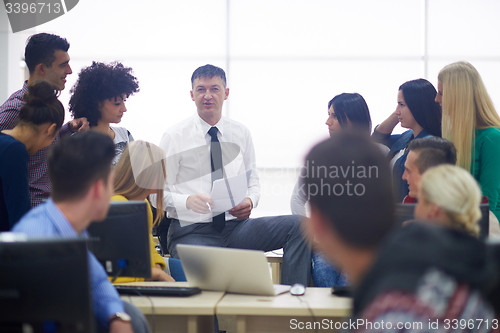 Image of students with teacher  in computer lab classrom