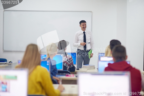 Image of students with teacher  in computer lab classrom