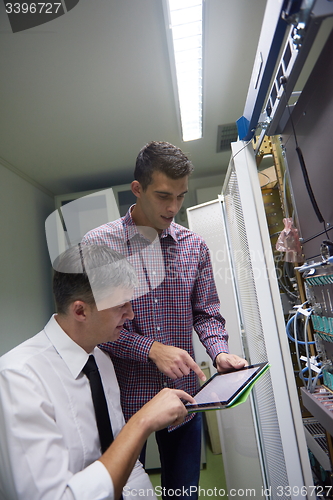 Image of network engineers in server room