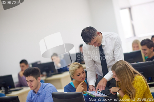 Image of students with teacher  in computer lab classrom