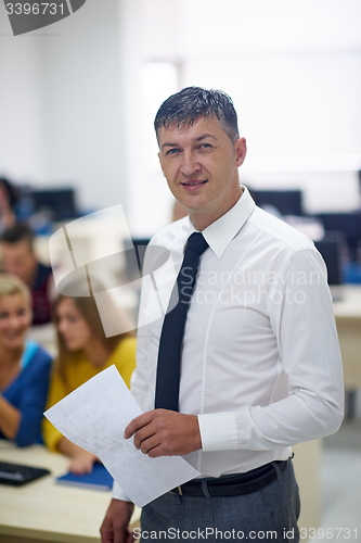 Image of students with teacher  in computer lab classrom