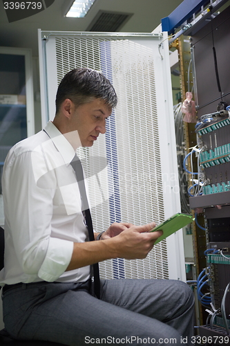 Image of network engineer working in  server room