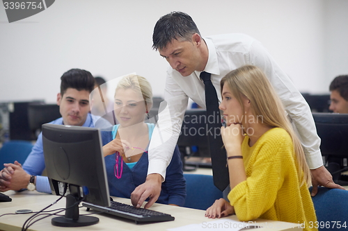 Image of students with teacher  in computer lab classrom