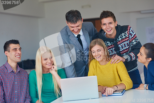 Image of group of students getting suppport from teacher