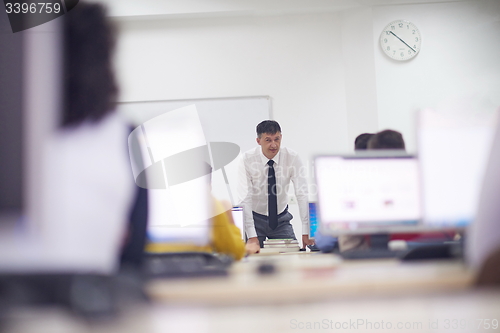 Image of students with teacher  in computer lab classrom