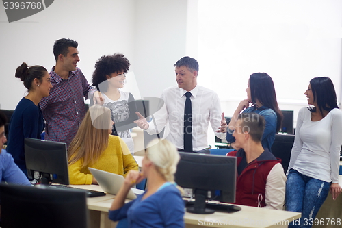 Image of students with teacher  in computer lab classrom