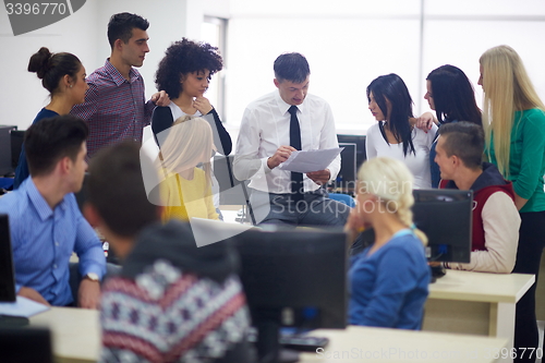 Image of students with teacher  in computer lab classrom