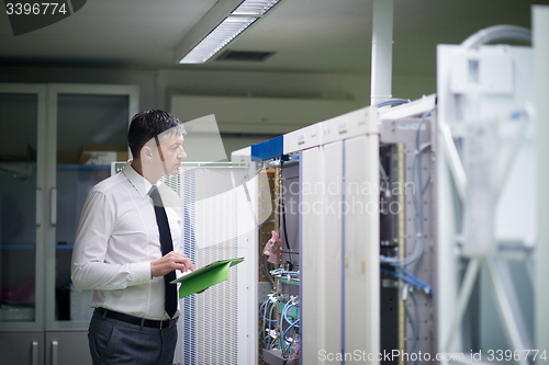 Image of network engineer working in  server room