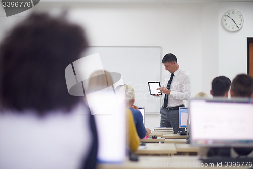 Image of students with teacher  in computer lab classrom