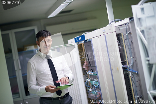 Image of network engineer working in  server room