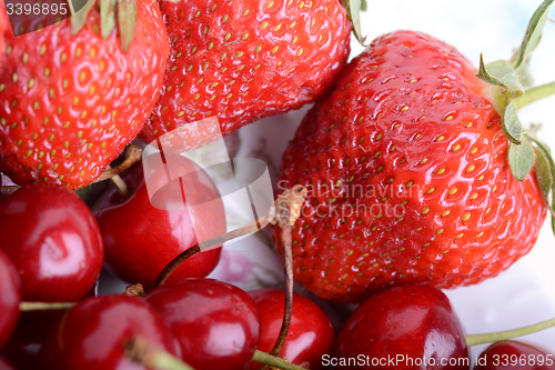 Image of Background from fresh ripe strawberries and cherry