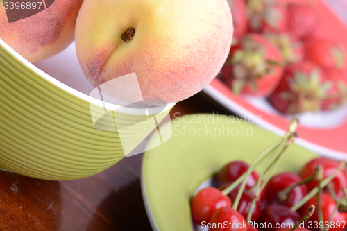 Image of fresh fruits and berries mixed collection surface close up, summer health food, peach, cherry, strawberry.